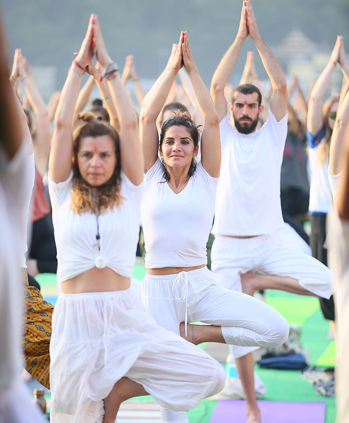 Students Practicing Yoga in Yoga Session at Yoga School Students Practicing Yoga in Yoga Session at Yoga School
