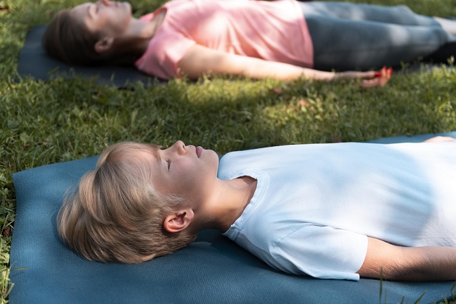 Kid Performing Savasana or Corpse Pose Kid Performing Savasana or Corpse Pose