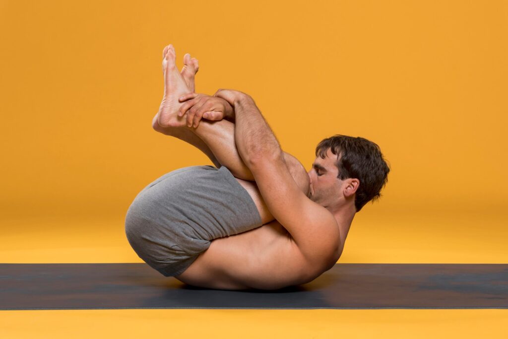 Yoga Student Practising Wind-Relieving Pose (Pawanmuktasana) Yoga Student Practising Wind-Relieving Pose (Pawanmuktasana)