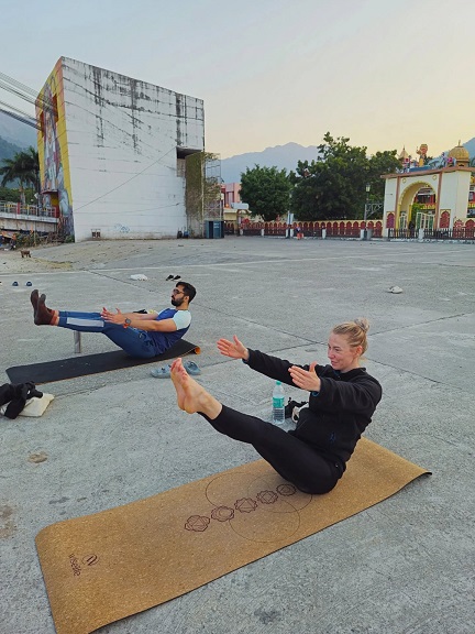 Student Performing Boat Pose at Rishikul Yogshala Rishikesh