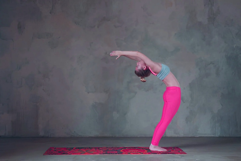 Yoga Student Performing Hasta Uttanasana Yoga Student Performing Hasta Uttanasana