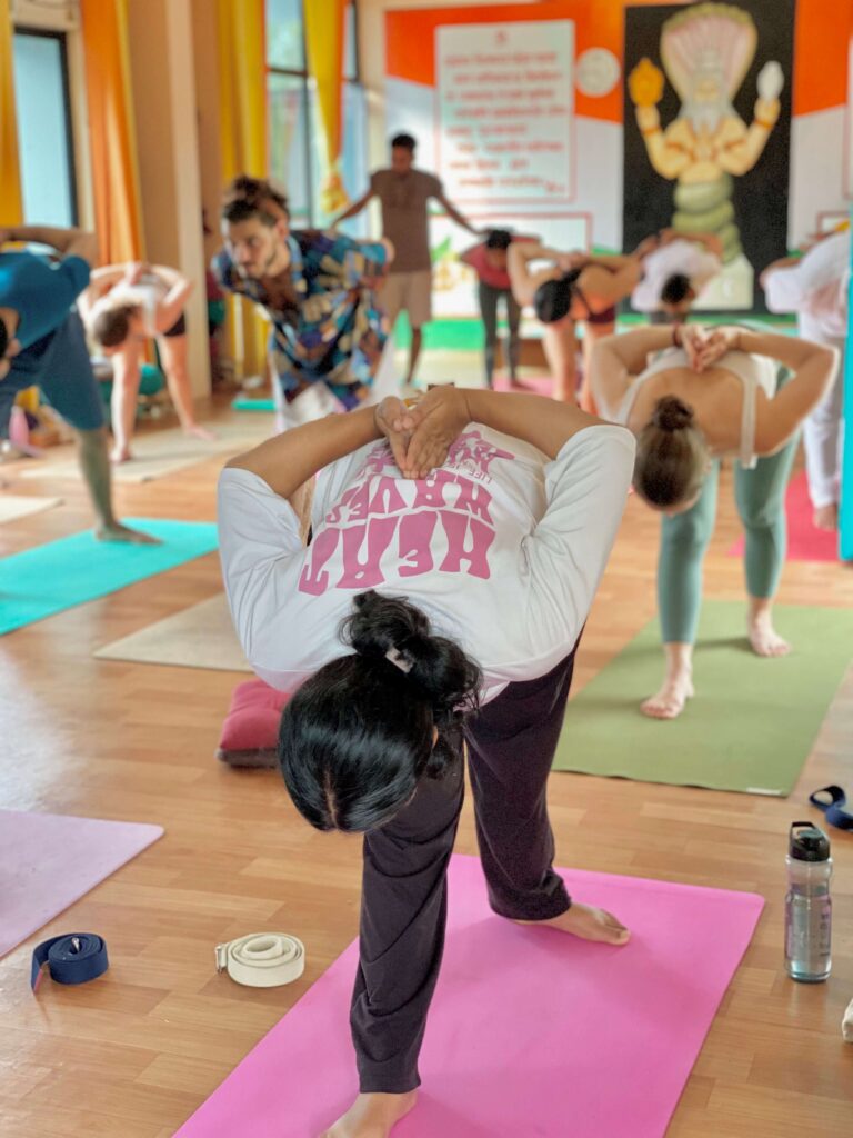 Yoga Students Practicing Intense Side Stretch Pose During Teacher Training in Rishikesh.