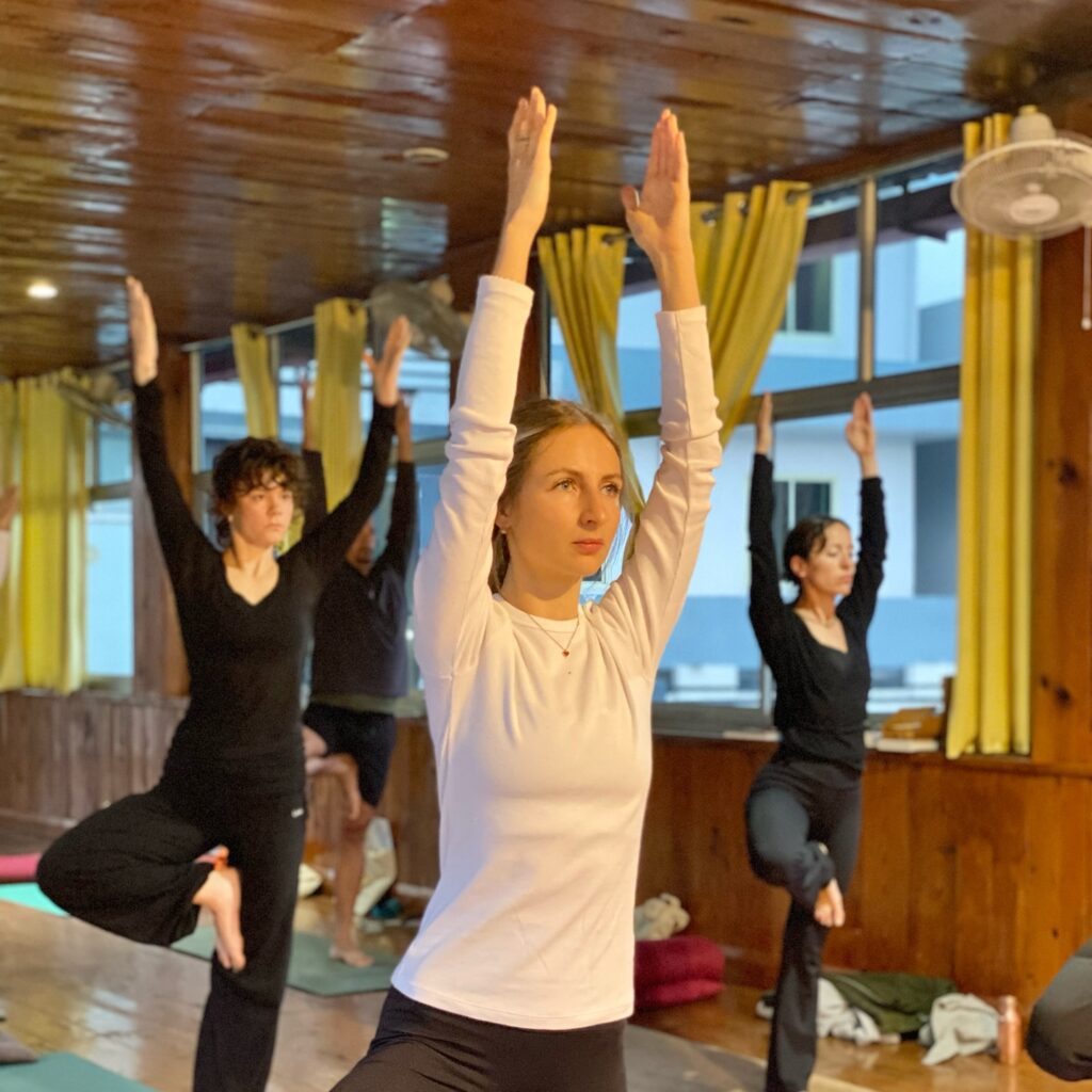 Student performing Tree Pose (Vrksasana) during yoga teacher training in Rishikesh