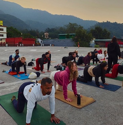 Student performing Cat-Cow Pose (Marjaryasana–Bitilasana) during yoga teacher training in Rishikesh