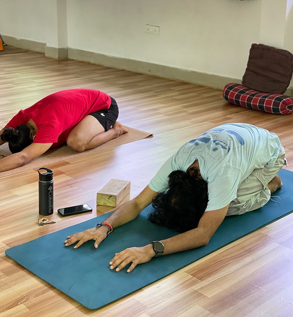 Student performing Child's Pose (Balasana) during yoga teacher training in Rishikesh