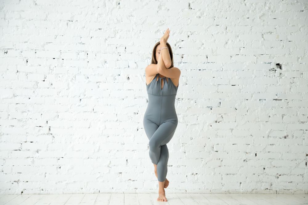 Women Practicing Eagle Pose Women Practicing Eagle Pose