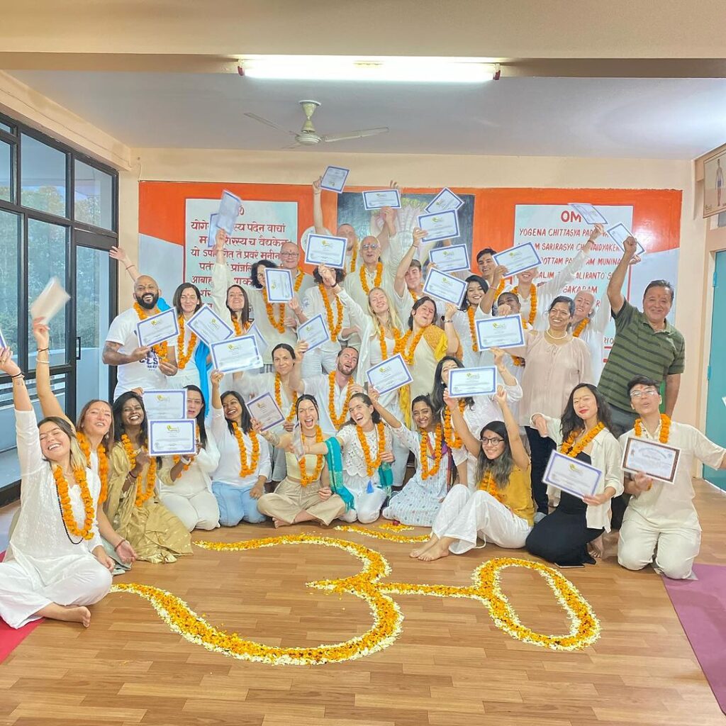 Why Yoga Teacher Training in Rishikesh Is the Greatest Option in India 2 Group of yoga students celebrating after receiving their Yoga Teacher Training certificates from Rishikul Yogshala
