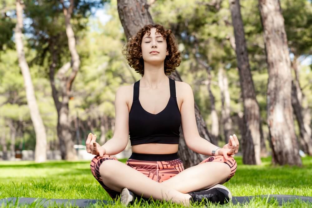 Woman Meditating in Sukhasana Woman Meditating in Sukhasana