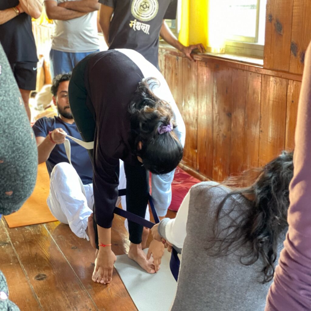 Student Practising Uttanasana During 200 hour YTTC at Rishikul Yogshala Rishikesh