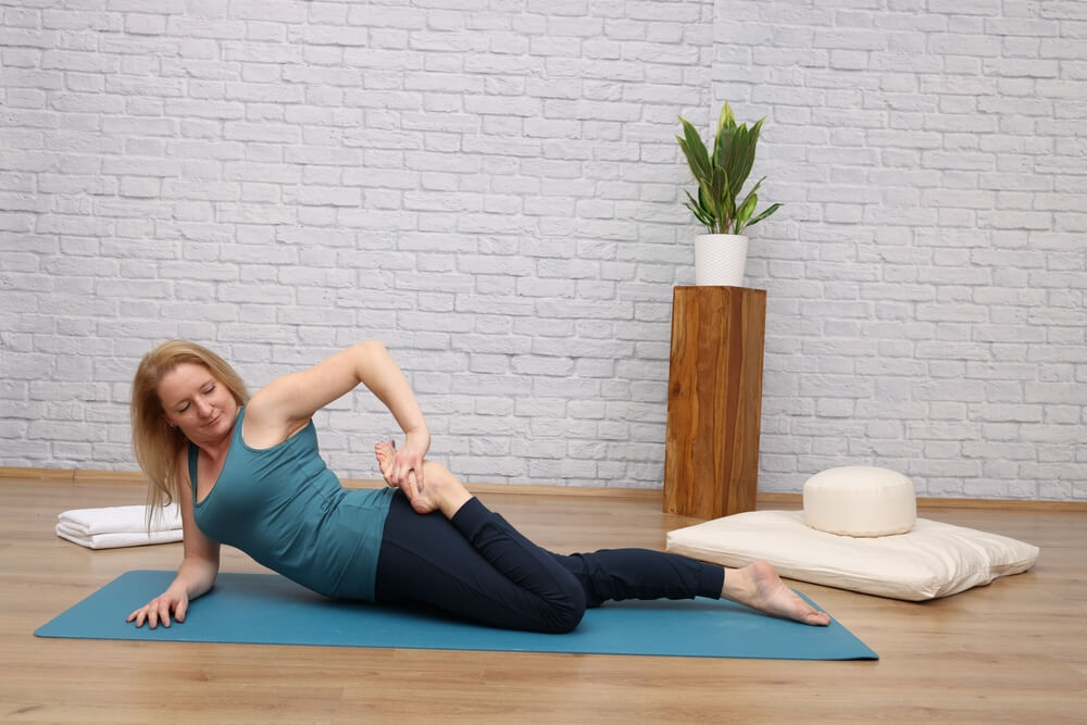Women Doing Half Frog Pose to Improve Flexibility Women Doing Half Frog Pose to Improve Flexibility