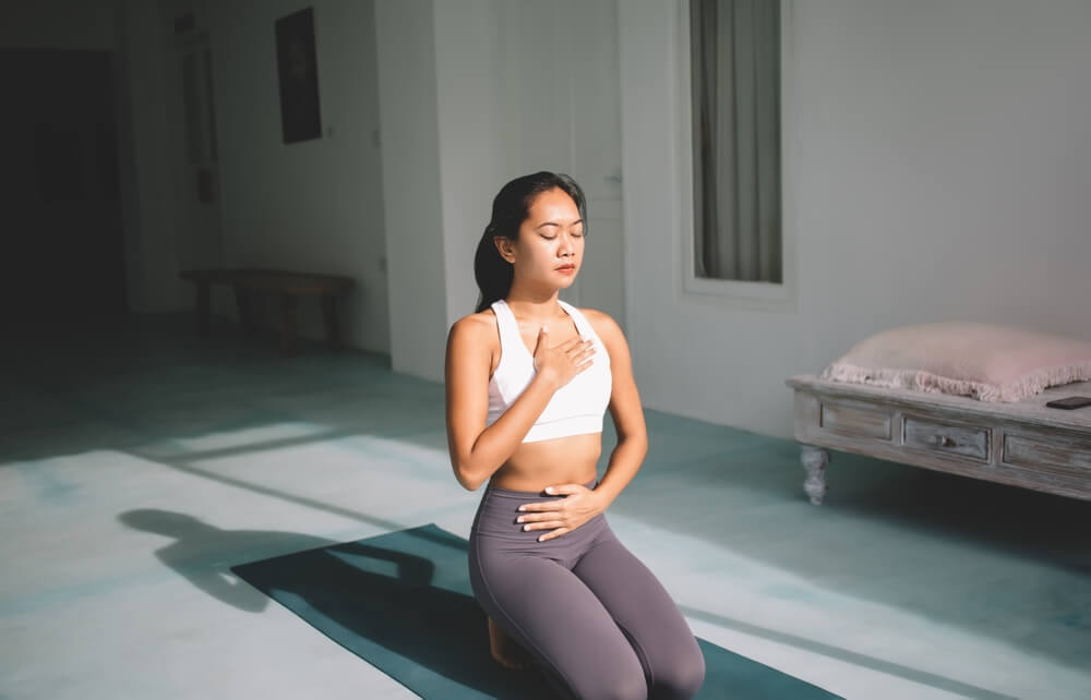 Yoga Student Practicing Deep Breathing Exercise Yoga Student Practicing Deep Breathing Exercise