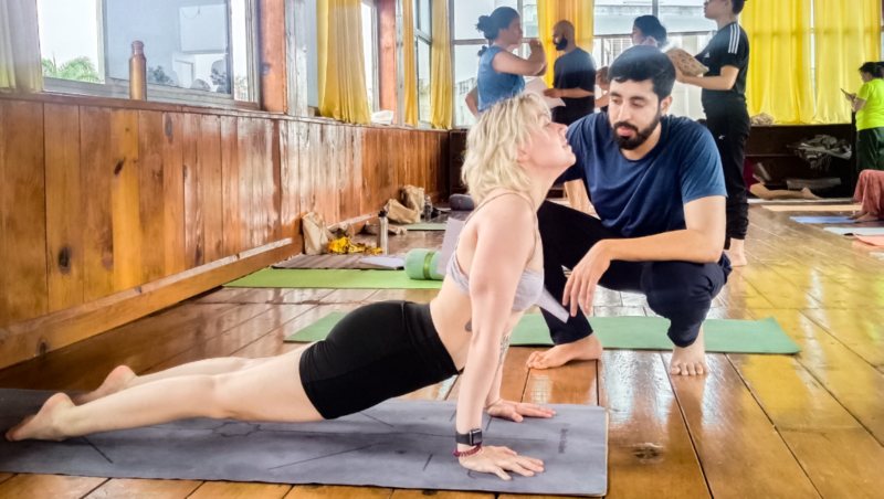 Penguin Yoga Pose & Benefit: A Close Relation to Pigeon Pose 2 student-practicing-yoga-pose