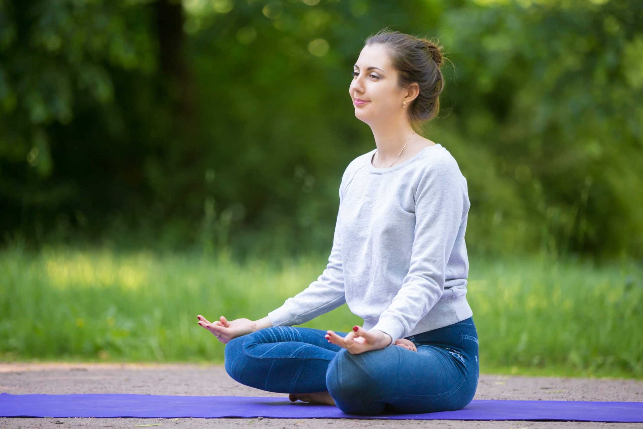 Student Performing Ardha Padmasana (Half Lotus Pose) Yoga in Nature Student Performing Ardha Padmasana (Half Lotus Pose) Yoga in Nature