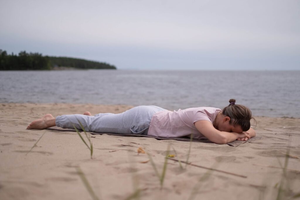 Crocodile Pose (Makarasana) on the Beach – Yoga for Deep Relaxation Crocodile Pose (Makarasana) on the Beach – Yoga for Deep Relaxation