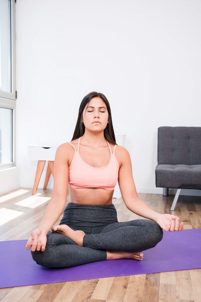 Teacher Performing Sukhasana Yoga Meditation at Rishikul Yogshala Teacher Performing Sukhasana Yoga Meditation at Rishikul Yogshala