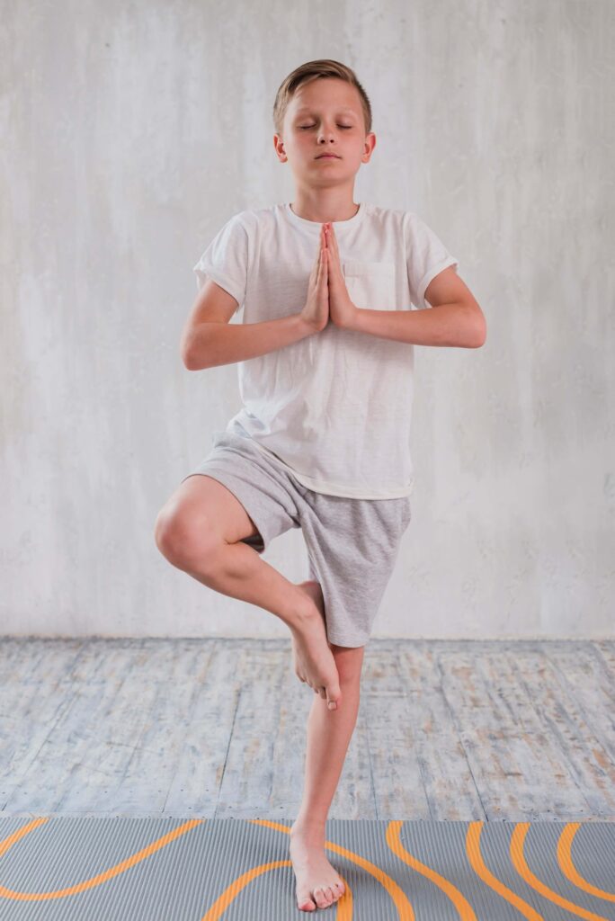 Child in Tree Pose (Vrikshasana) to Improve Balance and Focus Child in Tree Pose (Vrikshasana) to Improve Balance and Focus