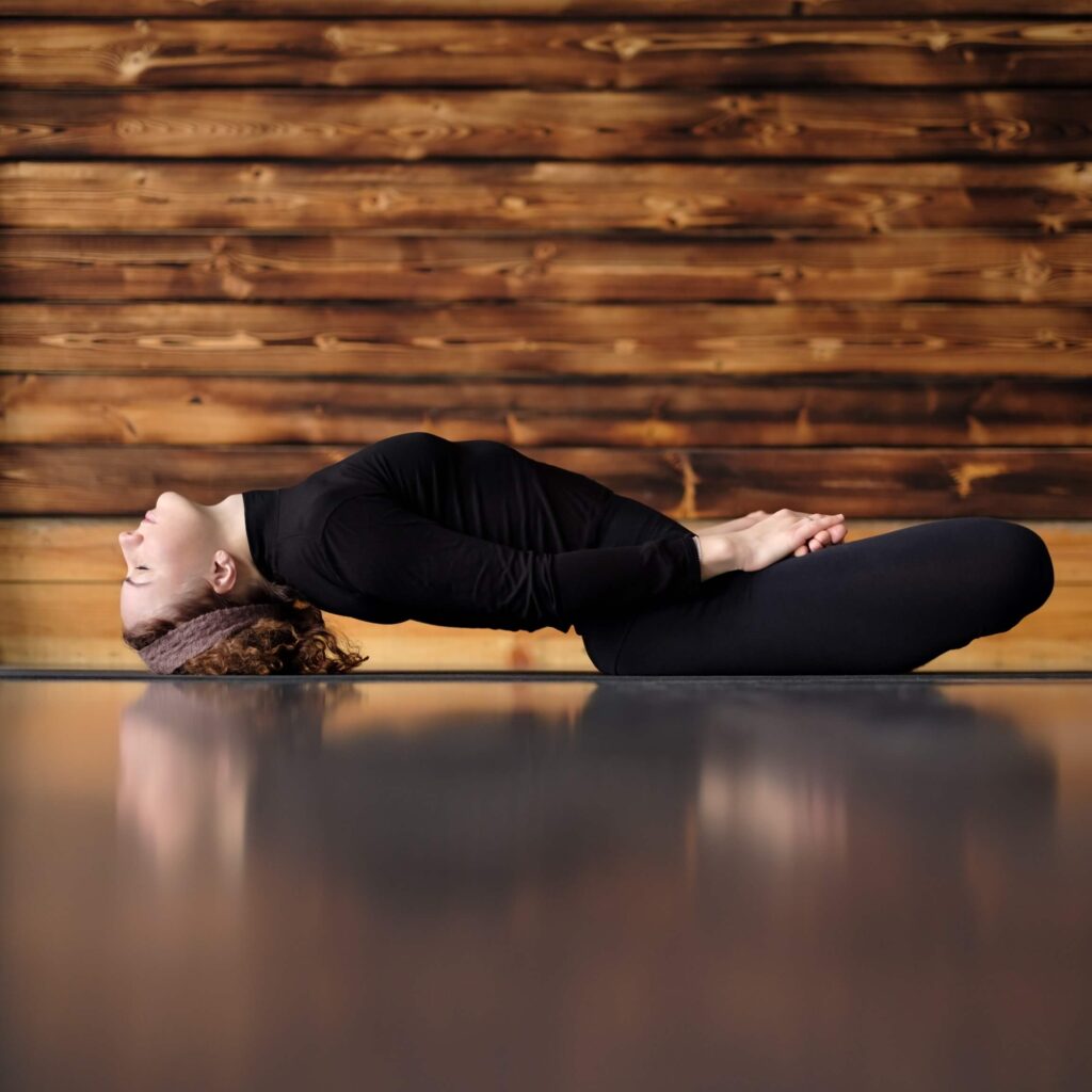 Woman practicing Fish Pose (Matsyasana) Woman practicing Fish Pose (Matsyasana)