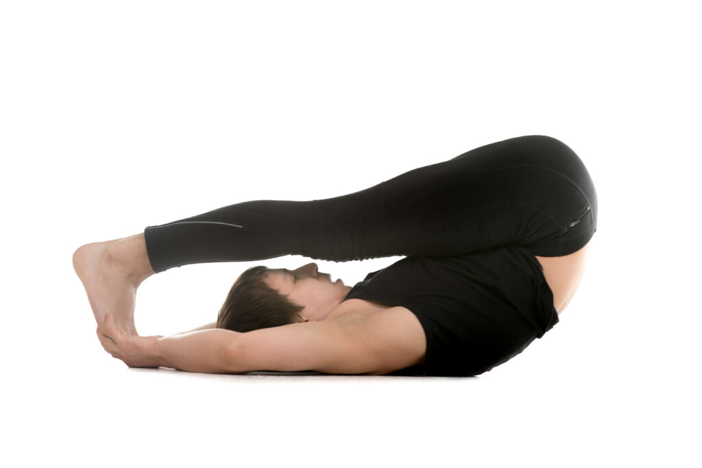 Student performing the Halasana (Plow Pose) Student performing the Halasana (Plow Pose)