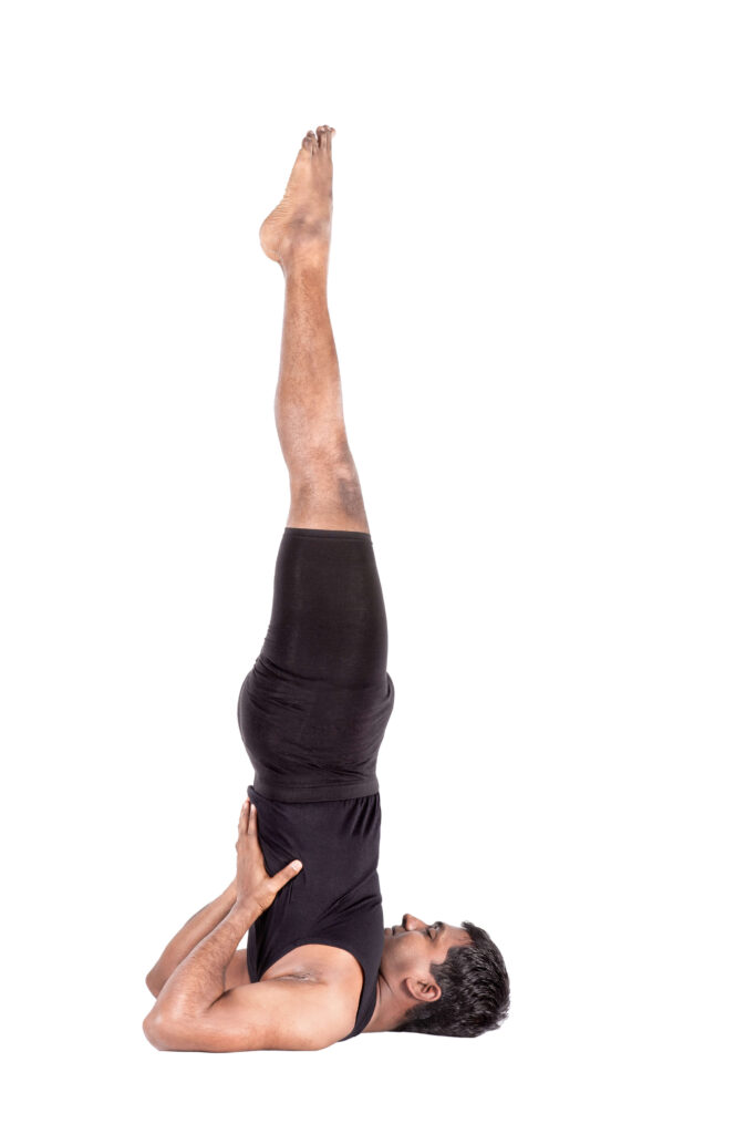 Yoga Teacher Performing Salamba Sarvangasana Yoga Teacher Performing Salamba Sarvangasana