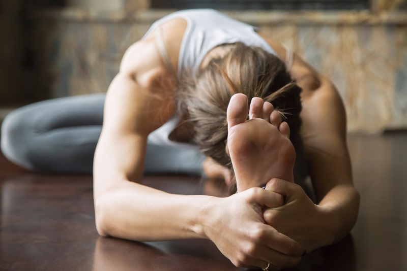 Student Practicing Janu Sirsasana for Better Digestion Student Practicing Janu Sirsasana for Better Digestion
