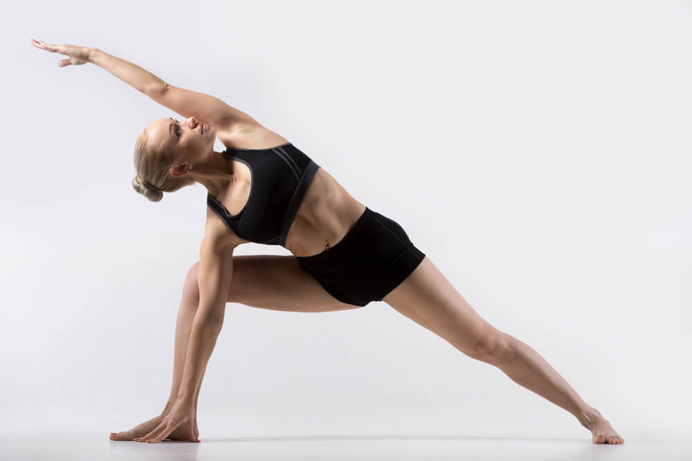 Teacher Practicing Extended Side Angle Pose in Yoga Teacher Practicing Extended Side Angle Pose in Yoga