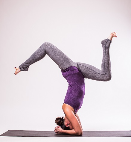 Student Practicing Sirsasana to Reduce Insomnia Student Practicing Sirsasana to Reduce Insomnia