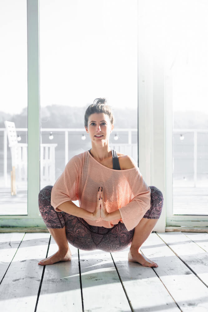 Women Practicing Garland Yoga Pose