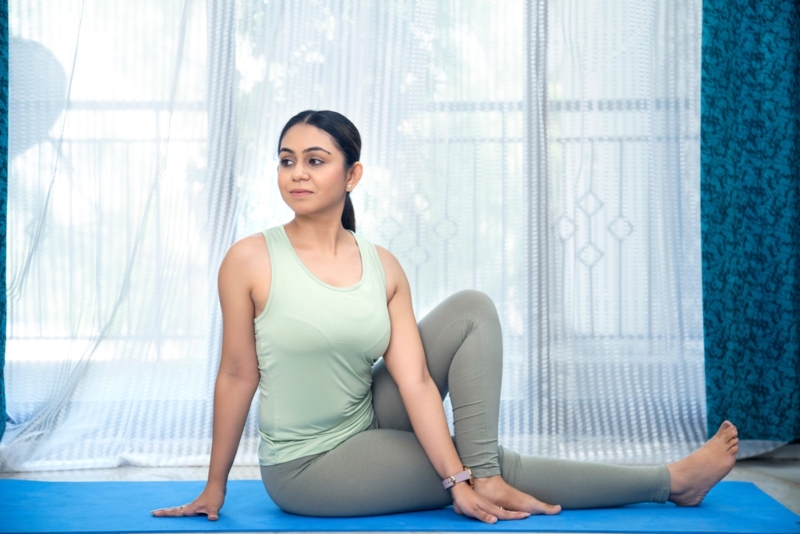 Women Performing Vakrasana Women Performing Vakrasana