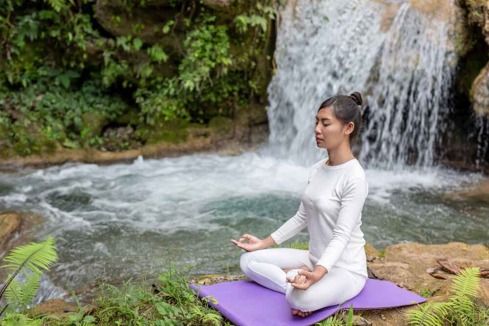 Woman doing meditation in Rishikesh 