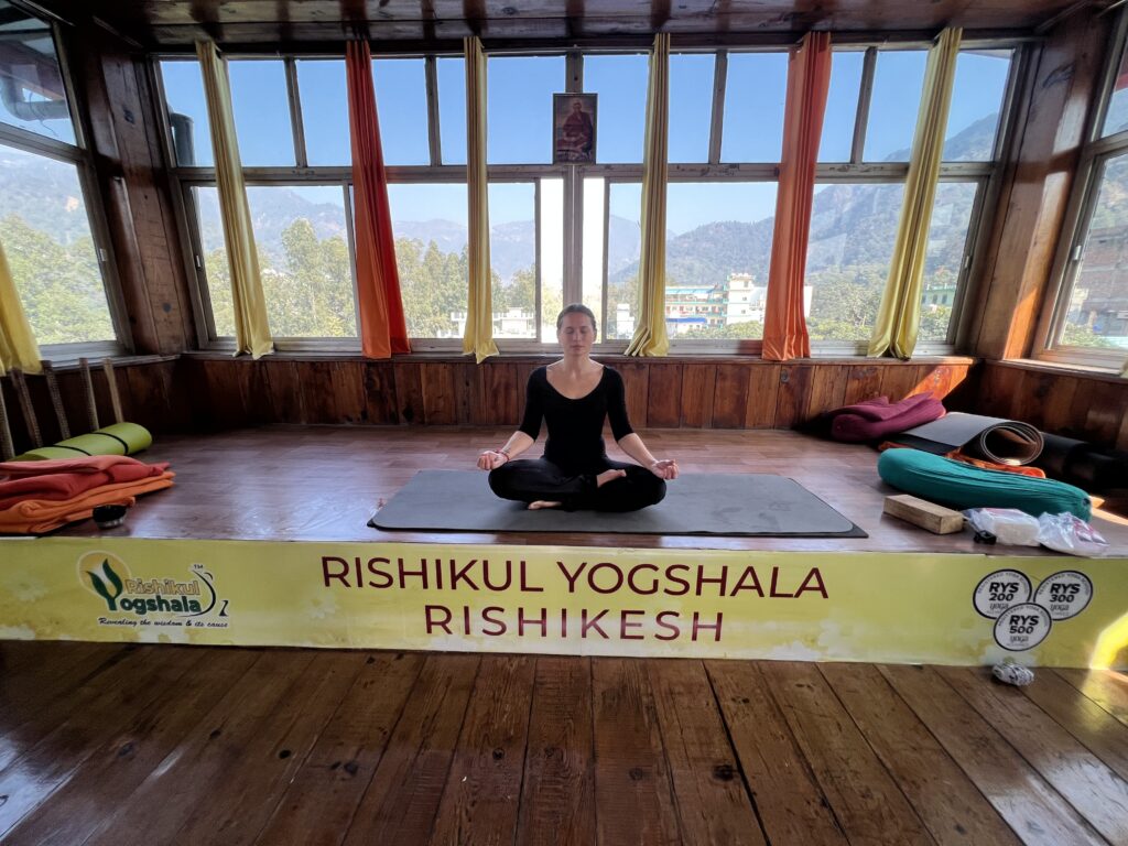 A Woman Practising Abdominal Lock at Rishikul Yogshala Rishikesh A Woman Practising Abdominal Lock at Rishikul Yogshala Rishikesh