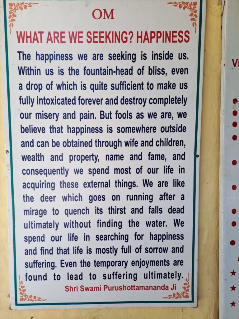 Signboard About Finding Happiness within by Shri Swami Purushottamananda Ji.