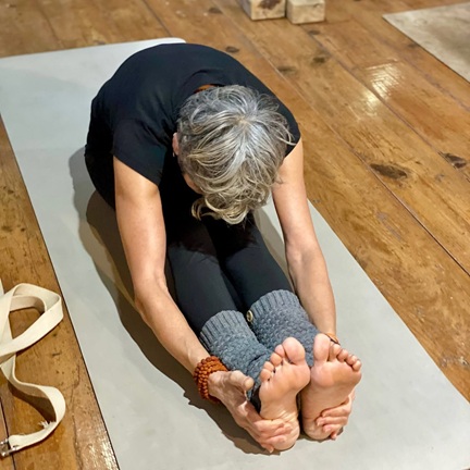 Student Practising Dandasana into Paschimottanasana During Yoga TTC at Rishikul Yogshala Rishikesh