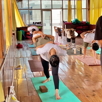 Student Pracising Parsvottanasana (Pyramid Pose) During Yoga Teacher Training in Rishikesh