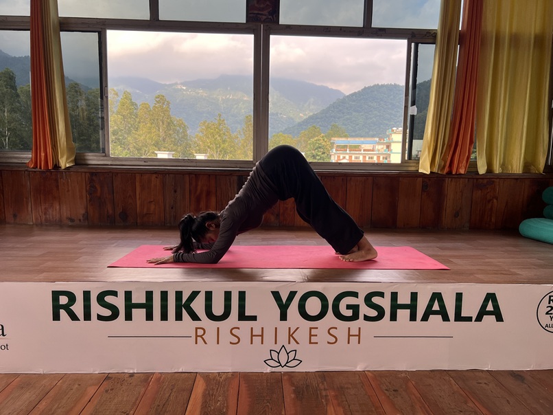 Student Performing Dolphin Pose