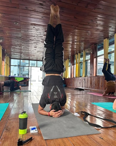Sirsasana (Headstand): A Gentle, Careful Guide to the King of Yoga Poses 2 Student Performing Sirsasana During Yoga Teacher Training in Rishikesh