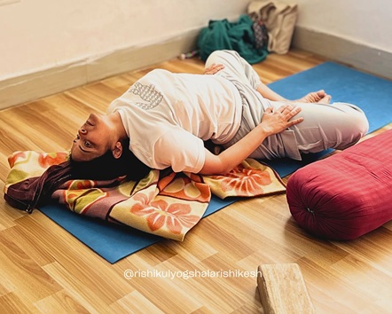 Student Practising Reclining Bound Angle Pose During 200 Hour Yoga Teacher Training in Rishikesh