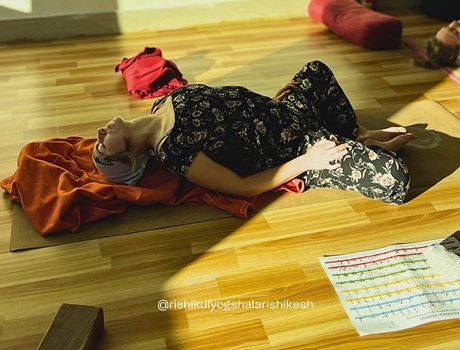 Student Practising Reclining Bound Angle Pose During 200 Hour Yoga Teacher Training in Rishikesh