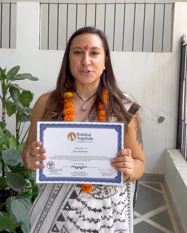 Student with her yoga teacher training certificate
